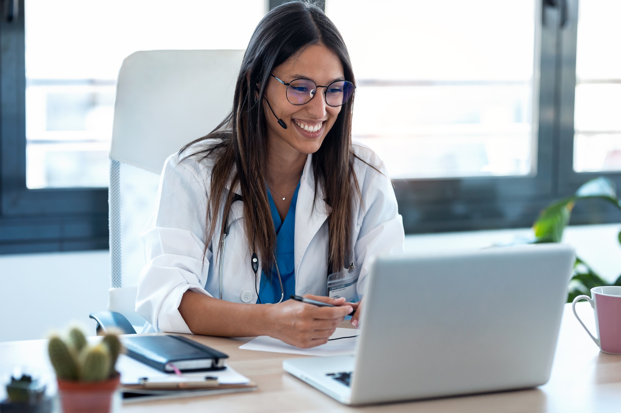 Female doctor conducting telehealth video consultation on laptop